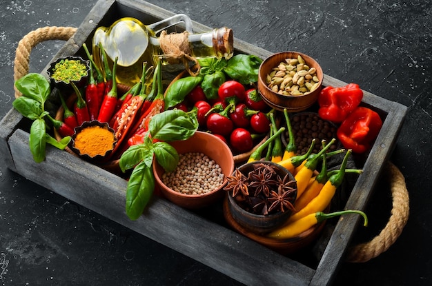 Set of colored chili peppers in a wooden box Mexican cuisine Spices Top view