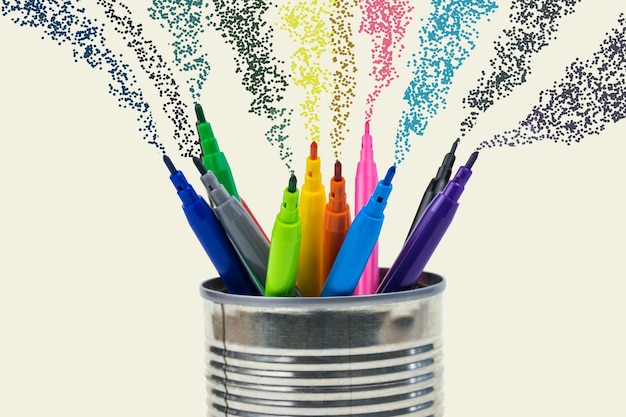 A set of colored markers on a light background with flying paint. Universal markers for school, office, and Hobbies.