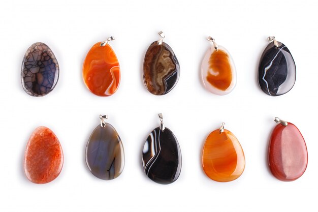 Set of colored onyx pendants isolated on white surface