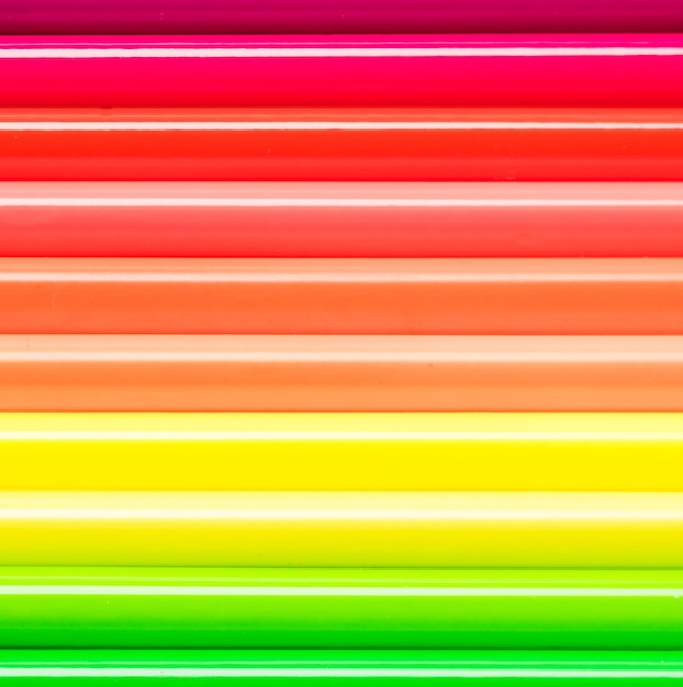 Set of colored pencils folded horizontally as a background Colored pencils in neon colors