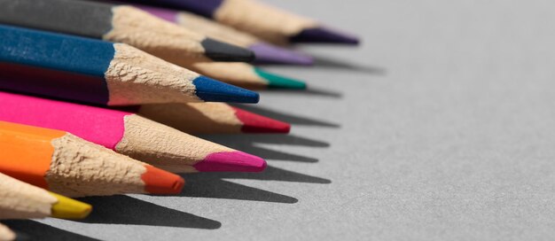 Set of colored pencils on grey table