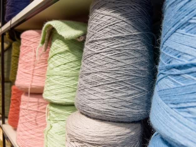 Set of colored yarn threads on bobbins