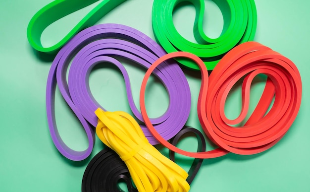 Photo a set of colorful elastic fitness band on blue background