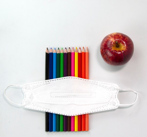 Set of colorful pencils face mask apple isolated on white background Back to school concept on Top