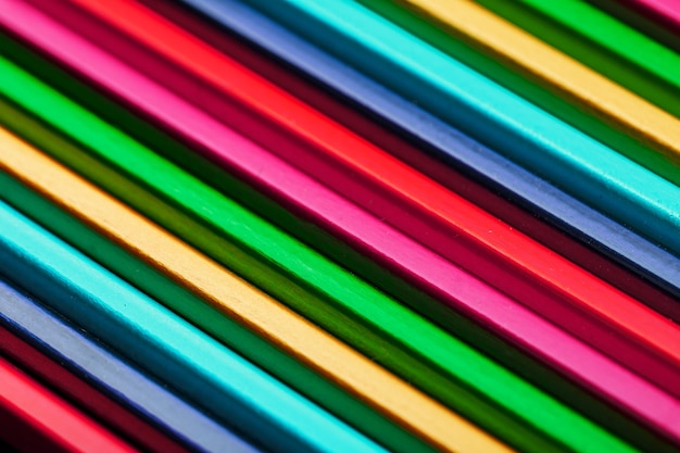 A set of colorful pencils on a textured dark background