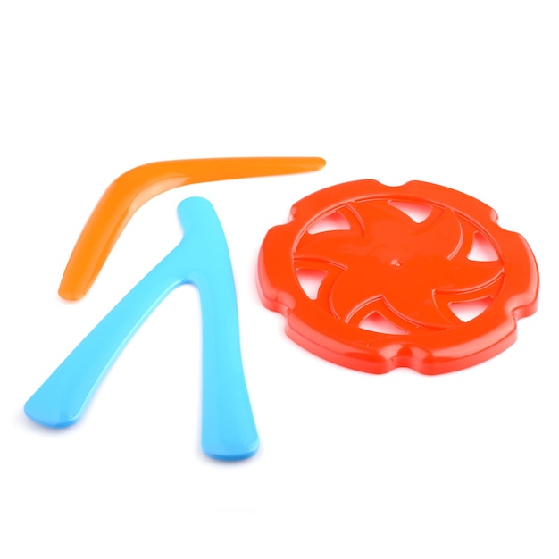 A set of colorful plastic boomerangs and frisbees for outdoor play Children's active games Boomerang isolated on a white background closeup