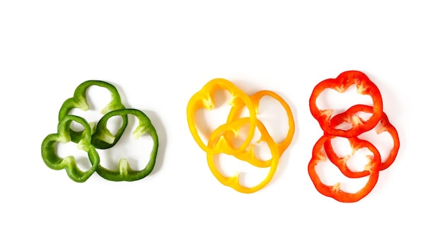 Set of colorful sliced bell pepper isolated on white Slices of red yellow and green bell pepper