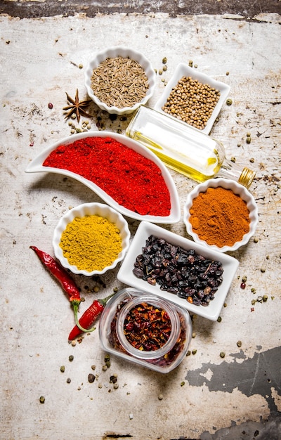 Set of colorful spices and herbs on on rustic table. Top view