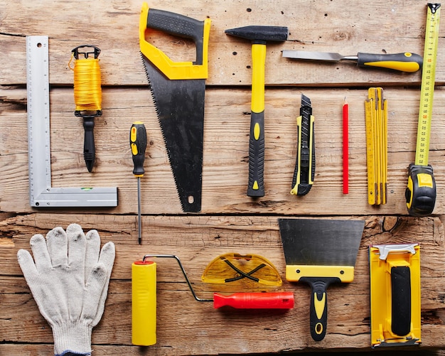 Photo set of construction tools on a wooden background top view