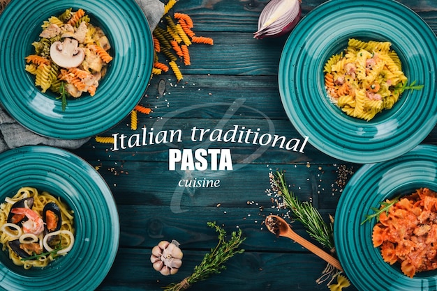 A set of cooked pastes in plates On a wooden background Italian cuisine Top view Copy space