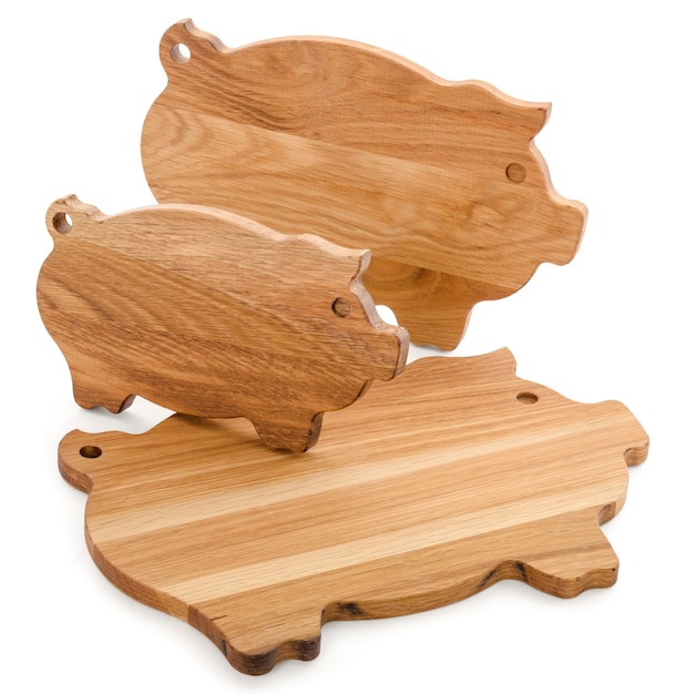 Set of cutting boards. Three wooden pigs isolated