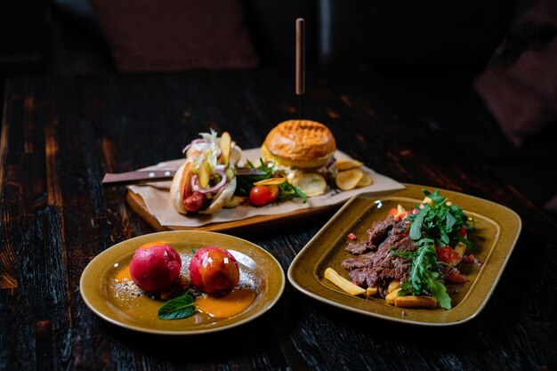 Set of delicious dishes on wooden table