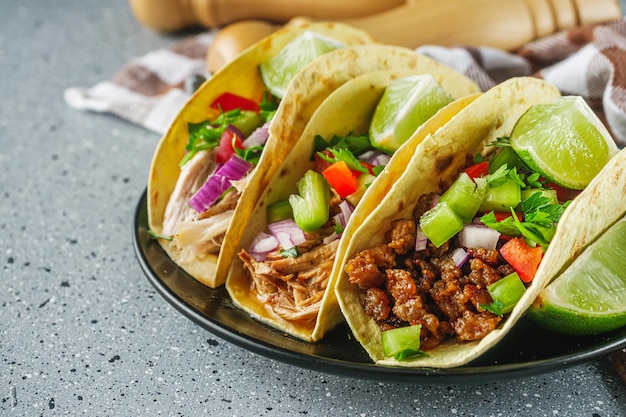 set of delicious juicy tacos on a light stone background