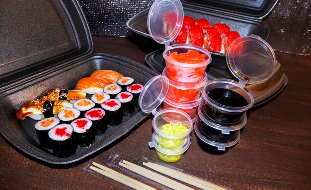 Set of delicious sushi rolls with wassabi and ginger in a box Japanese food