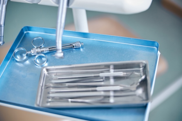 Set of dental instruments on metal tray