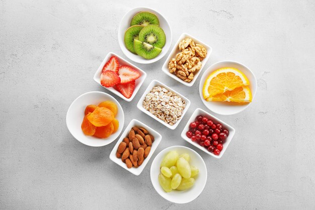 Set of diet products in saucers on grey textured background