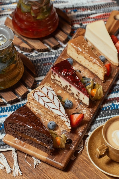 Set of different cake slices on wooden table