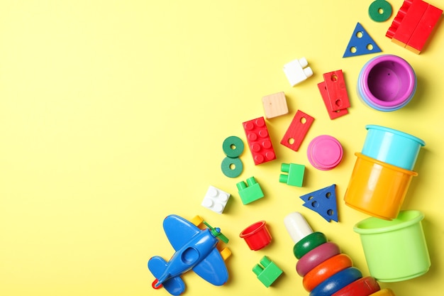 Set of different childrens toys on a colored background top view