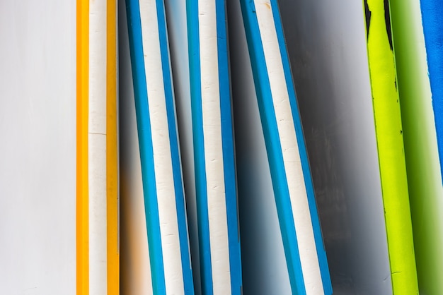 Set of different color surf boards in a stack. France