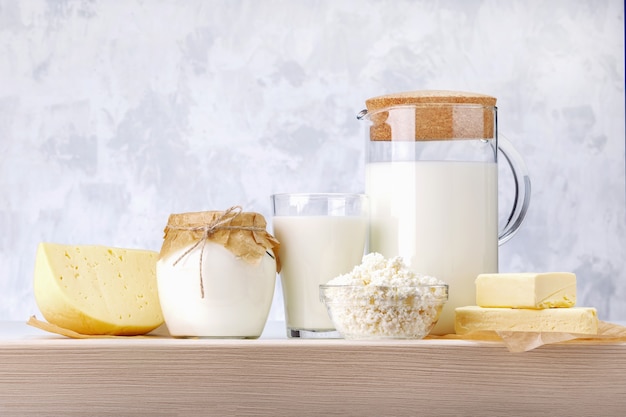 Set of different dairy products on wooden table.