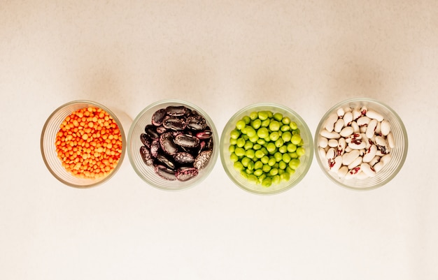 Set of different dried legumes in glasses