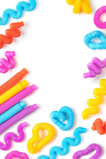 Set of different forms and colors, trendy kids toys Ã¢ÂÂ pop-tubes. White background with colorful kids toys with copy space.