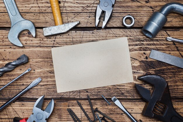 Photo set of different repair tools on wooden background with copy space.