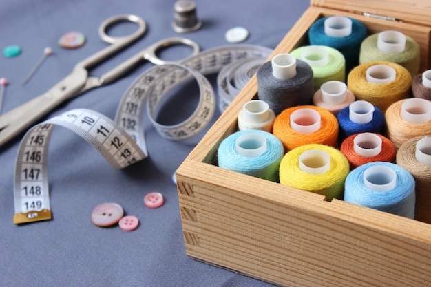 set of different sewing accessories on a colored background closeup