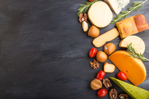 Set of different types of cheese with rosemary and tomatoes