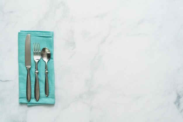 Set of dining silverware on linen dinner napkin.