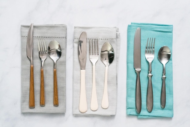 Set of dining silverware on linen dinner napkin.