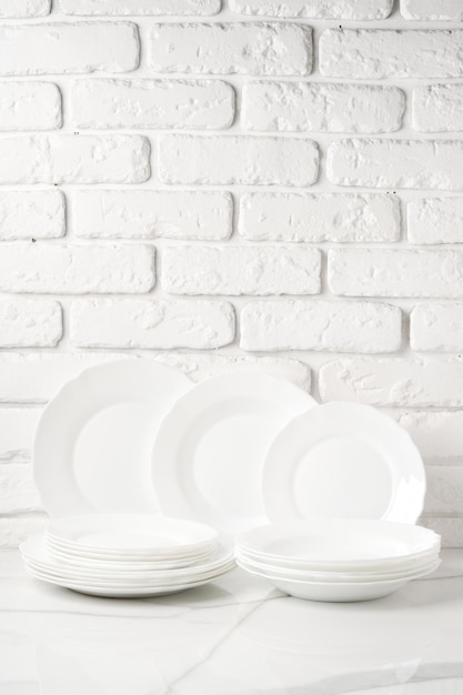 Set of dishes on table against brick wall background