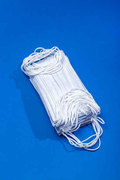 A set of disposable medical masks on a blue background