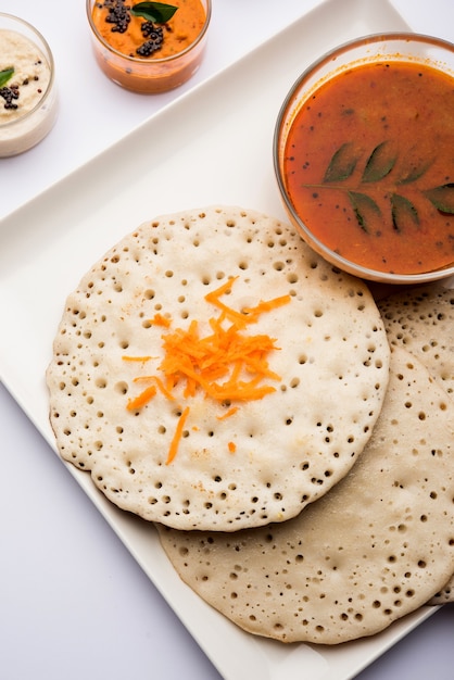 Set Dosa, Oothappam or uttapam style dosa is a popular south Indian food served with sambar and chutney, selective focus