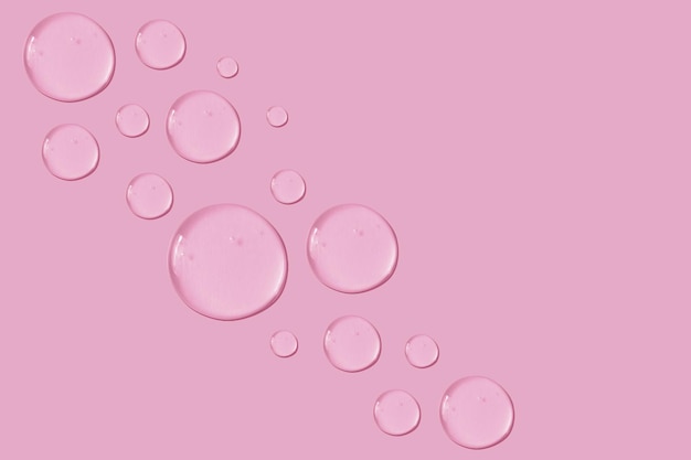 Set of drops of gel texture on a pink background