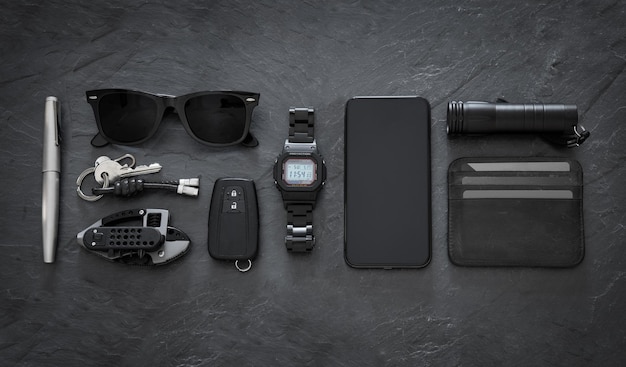 Photo set of edc every day carry items on dark background