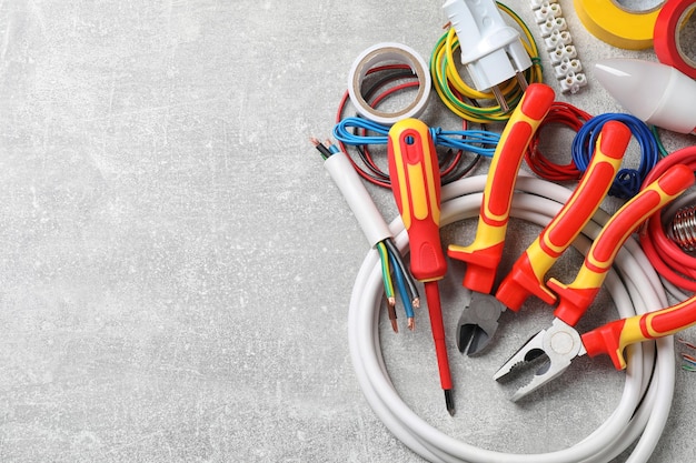 Set of electrician39s tools and accessories on grey background space for text