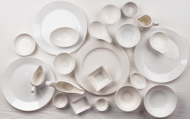 Set of empty dishware on white surface