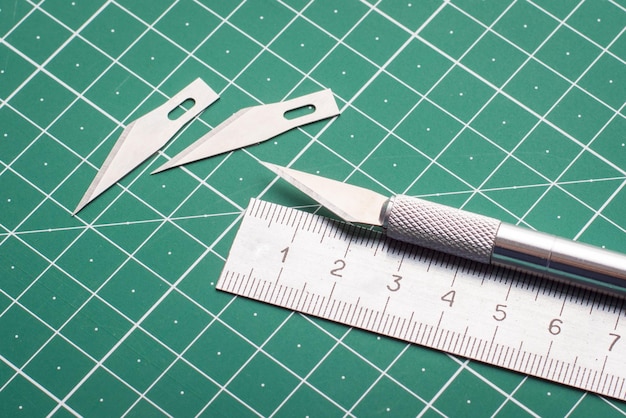 Set of equipment for cutting paper. Scalpel, ruler and two sharp blades