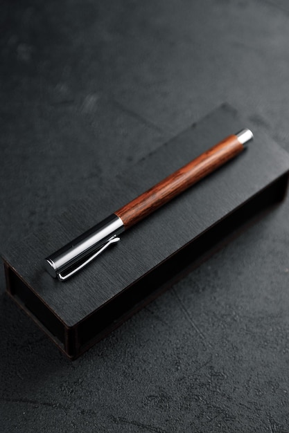 A set of expensive pens in wooden boxes on a dark background\
with attributes luxury gift pen