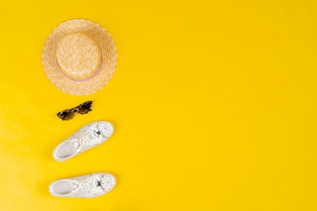 Set of female clothes and accessories on bright yellow background