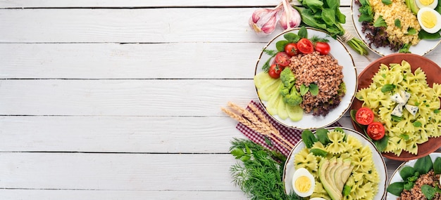 A set of food from buckwheat bulgur and pasta On a wooden background Top view Copy space