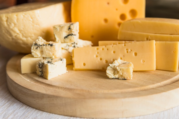 Photo set of fresh cheese on wood chopping board