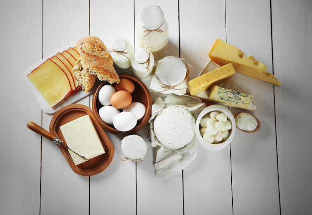 Set of fresh dairy products on white wooden table