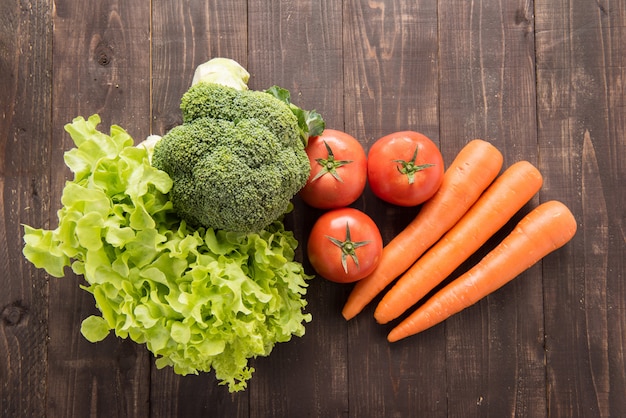 Photo set of fresh vegetables on wood table.