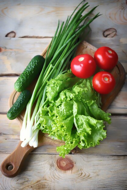 Set of fresh vegetables on a wooden board