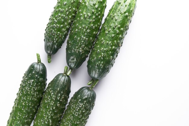 Set of fresh whole cucumbers on white background, food pattern. Garden cucumber wallpaper backdrop design