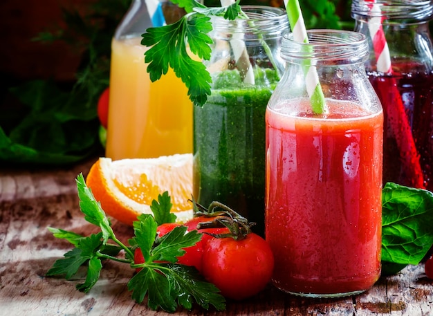 Set of fruit and vegetable juices old wooden background selective focus