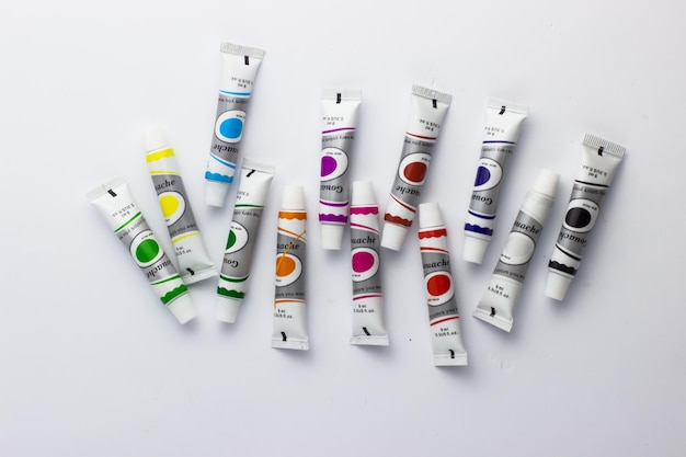 A set of gouache paints on a white background Colorful paints School inventory