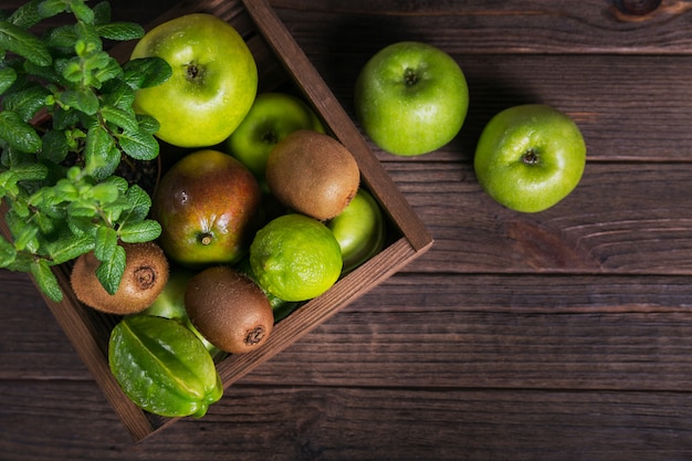 Set of green fruits for healthy diet and detox: apple, lime, kiwi, mango, carambola and mint